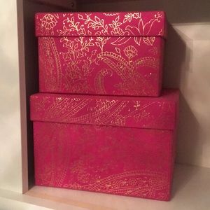 Two hot pink boxes with gold accents